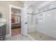 Modern bathroom with tiled shower and seat adjacent to bedroom at 2941 Mt Vernon Church Rd, Raleigh, NC 27613