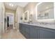 Bathroom vanity with dual sinks, granite countertops, modern lighting and a large mirror at 2941 Mt Vernon Church Rd, Raleigh, NC 27613