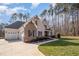 Spacious home with a three-car garage and a well-manicured lawn, showcasing its curb appeal at 2941 Mt Vernon Church Rd, Raleigh, NC 27613