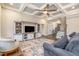 Cozy living room with coffered ceiling, open staircase, and modern entertainment center at 2941 Mt Vernon Church Rd, Raleigh, NC 27613