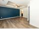 Spacious bedroom with a tray ceiling, ceiling fan, and an adjoining bathroom at 3836 Prince Noah Loop, Wake Forest, NC 27587