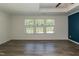 Bedroom with a tray ceiling, stylish floors, and large windows overlooking the yard at 3836 Prince Noah Loop, Wake Forest, NC 27587