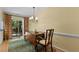 Cozy dining room featuring hardwood floors, chandelier, and sliding doors leading to the outdoors at 3929 Browning Pl, Raleigh, NC 27609