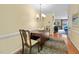 Small dining room with hardwood floors, chandelier, and views to the living room at 3929 Browning Pl, Raleigh, NC 27609