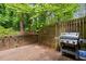 This patio area is surrounded by lush greenery and a wooden fence for added privacy at 3929 Browning Pl, Raleigh, NC 27609