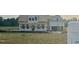 Exterior elevation of home in the framing stage with a large yard and builder's sign visible at 3943 Baileys Xrds Rd, Benson, NC 27504