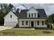 Charming two-story home featuring a welcoming front porch, attached two-car garage, and a well-manicured lawn at 3943 Baileys Xrds Rd, Benson, NC 27504