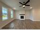 Spacious living room with a ceiling fan, fireplace, and ample natural light at 3943 Baileys Xrds Rd, Benson, NC 27504
