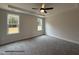 Main bedroom with tray ceiling, ceiling fan, and natural light from large windows at 3943 Baileys Xrds Rd, Benson, NC 27504