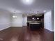 An open kitchen and dining area with dark cabinets, stainless steel appliances, and hardwood floors at 3947 Foxglove Trl, Burlington, NC 27215