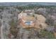 Sprawling property featuring a charming two-story home, large garage, and cleared land with surrounding trees at 3958 Buckhorn Rd, Sanford, NC 27330