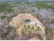 Expansive aerial shot of a home with a garage and garden area on a large, wooded property at 3958 Buckhorn Rd, Sanford, NC 27330