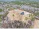 Captivating aerial perspective of a home and detached garage surrounded by wooded land at 3958 Buckhorn Rd, Sanford, NC 27330