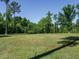 The expansive green lawn and mature trees provide a peaceful and private setting at 3958 Buckhorn Rd, Sanford, NC 27330