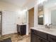 Bathroom featuring double sinks, dark cabinets, marble countertops, and wood-look tile at 3958 Buckhorn Rd, Sanford, NC 27330