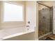 Bathroom featuring a soaking tub and a glass enclosed shower with stone tile at 3958 Buckhorn Rd, Sanford, NC 27330