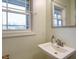 Bathroom with a sink, faucet, mirror, and bright window showing natural light at 3958 Buckhorn Rd, Sanford, NC 27330