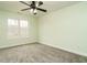 Spacious carpeted bedroom featuring a ceiling fan, natural light, and fresh paint at 3958 Buckhorn Rd, Sanford, NC 27330