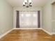 Bright dining room with hardwood floors, large windows with sheer curtains and neutral paint at 3958 Buckhorn Rd, Sanford, NC 27330