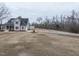 A full view of the home, including solar panels, a long driveway, and surrounding trees at 3958 Buckhorn Rd, Sanford, NC 27330