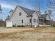 Rear exterior view of a two-story home featuring gray siding, a screened porch, and an attached two-car garage at 3958 Buckhorn Rd, Sanford, NC 27330