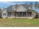 Exterior view of the home, including the lawn, roof, and screened porch at 3958 Buckhorn Rd, Sanford, NC 27330