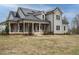 Charming gray home featuring a covered porch, solar panels and professionally landscaped yard at 3958 Buckhorn Rd, Sanford, NC 27330