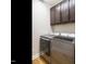 Laundry room featuring stainless steel washer and dryer and dark cabinets at 3958 Buckhorn Rd, Sanford, NC 27330