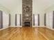 Open-concept living room with a vaulted ceiling, hardwood floors, and a floor-to-ceiling stone fireplace at 3958 Buckhorn Rd, Sanford, NC 27330