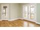 Inviting living room with hardwood floors and access to the outdoor porch through a glass door at 3958 Buckhorn Rd, Sanford, NC 27330