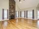 Spacious living room featuring a stone fireplace, vaulted ceilings, and large windows for natural light at 3958 Buckhorn Rd, Sanford, NC 27330