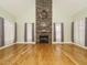 Bright living room with a floor-to-ceiling stone fireplace and large windows allowing for ample natural light at 3958 Buckhorn Rd, Sanford, NC 27330