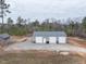 View of outbuilding with three garage doors surrounded by mature trees at 3958 Buckhorn Rd, Sanford, NC 27330