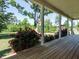 Spacious porch with wood flooring and landscaping with roses at 3958 Buckhorn Rd, Sanford, NC 27330
