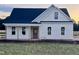 Charming single-story home with a covered porch and black roof ready for new owner at 3963 Baileys Xrds Rd, Benson, NC 27504