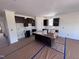 Spacious kitchen area with dark cabinets, an island, and natural light at 3963 Baileys Xrds Rd, Benson, NC 27504
