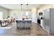 Modern kitchen with an island with seating, stainless steel appliances, and an adjacent dining area for entertaining at 3963 Baileys Xrds Rd, Benson, NC 27504
