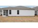 Side of house with windows and a screen door, with brown grass at 470 Bramble Ln, Clayton, NC 27527