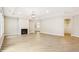 Open-concept living room featuring a fireplace, lots of natural light and modern laminate flooring at 470 Bramble Ln, Clayton, NC 27527