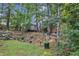 Spacious backyard with a small yard, tiered garden, mature trees, and a tranquil, wooded setting at 500 Creek Valley Dr, Fuquay Varina, NC 27526