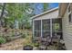 A charming backyard featuring a screened porch, fire pit and beautifully terraced garden beds at 500 Creek Valley Dr, Fuquay Varina, NC 27526