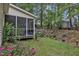 This backyard features a screened in porch, patio area, and lush greenery at 500 Creek Valley Dr, Fuquay Varina, NC 27526