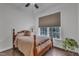 Bedroom with hardwood floors, neutral walls, and a window overlooking the backyard at 500 Creek Valley Dr, Fuquay Varina, NC 27526