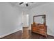 Simple bedroom with hardwood floors, large wooden dresser and connecting bathroom at 500 Creek Valley Dr, Fuquay Varina, NC 27526
