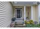 Charming front entrance with a black door, white columns, and decorative potted plants at 500 Creek Valley Dr, Fuquay Varina, NC 27526