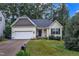 Charming single-story home with a well-manicured lawn, attached garage, and inviting front porch at 500 Creek Valley Dr, Fuquay Varina, NC 27526