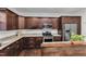 Gourmet kitchen featuring stainless steel appliances, granite countertops, and dark cabinets with crown molding at 500 Creek Valley Dr, Fuquay Varina, NC 27526