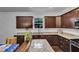 Well-appointed kitchen with granite countertops, dark cabinets, and an undermount sink under a bright window at 500 Creek Valley Dr, Fuquay Varina, NC 27526