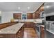 Modern kitchen featuring stainless steel appliances, granite countertops, and dark wood cabinetry at 500 Creek Valley Dr, Fuquay Varina, NC 27526