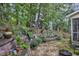 Beautifully landscaped backyard with retaining walls, greenery and decorative garden ornaments at 500 Creek Valley Dr, Fuquay Varina, NC 27526